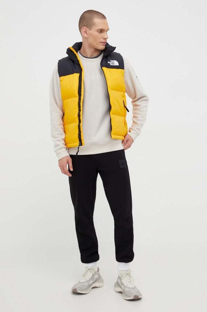 Пухова безрукавка The North Face чоловічий колір жовтий зимовий