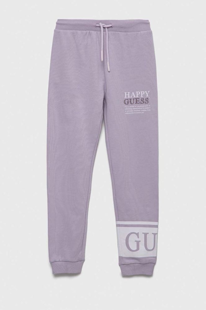 Дитячі бавовняні штани Guess колір фіолетовий з принтом